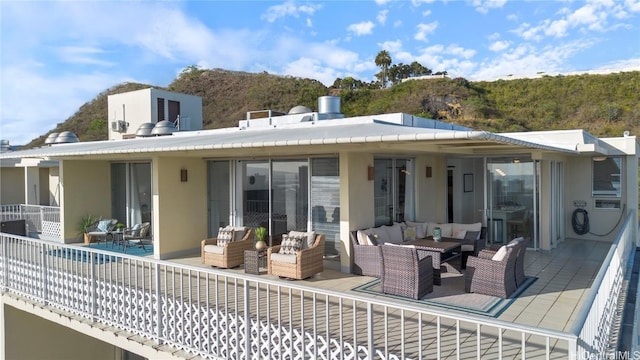 back of house featuring an outdoor hangout area