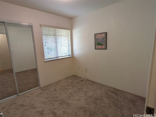 unfurnished bedroom with carpet and a closet