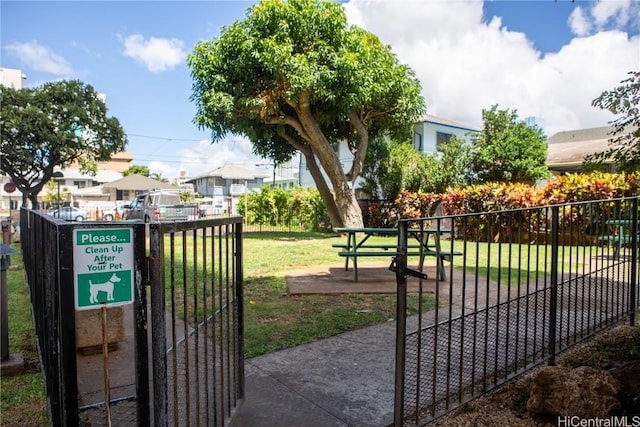 view of gate with a yard