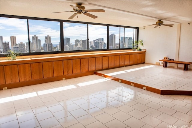 unfurnished room with light tile patterned flooring and a textured ceiling