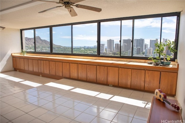 interior space with a mountain view and a textured ceiling