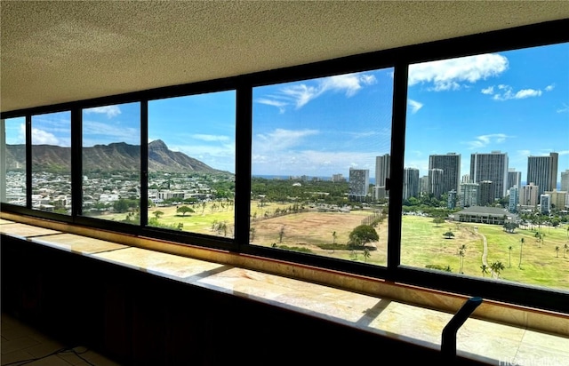 unfurnished sunroom with a mountain view