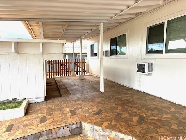 view of patio featuring a wall unit AC