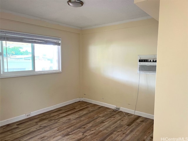 spare room featuring ornamental molding and dark hardwood / wood-style flooring