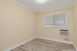 spare room featuring crown molding and light wood-type flooring