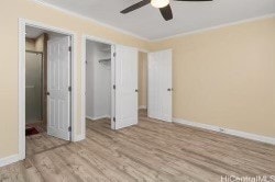 unfurnished bedroom with ornamental molding, a closet, light wood-type flooring, and ceiling fan