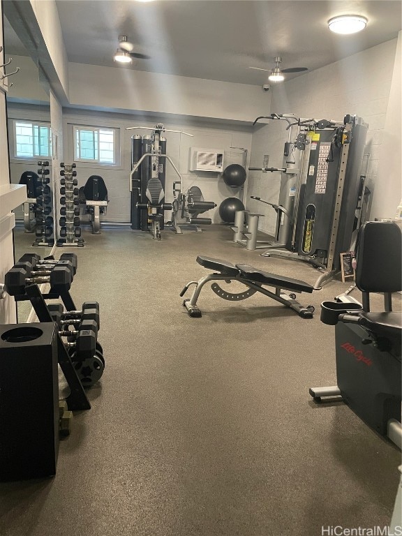 exercise room with ceiling fan