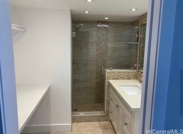 bathroom featuring vanity, tile patterned floors, and walk in shower