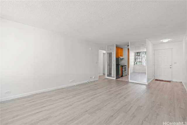 unfurnished living room with a textured ceiling and light wood-type flooring