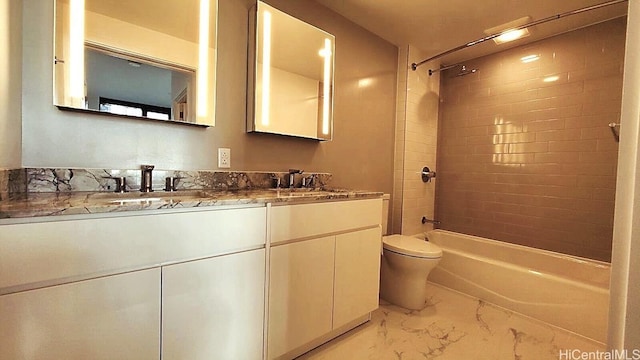 full bathroom featuring a sink, double vanity, toilet, marble finish floor, and bathing tub / shower combination
