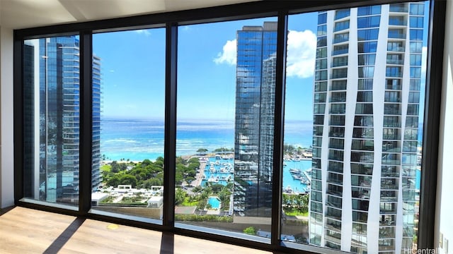 doorway to outside with a water view and hardwood / wood-style flooring