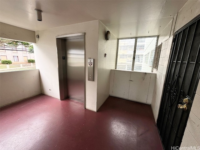 unfurnished room featuring elevator