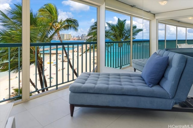 sunroom / solarium featuring a water view