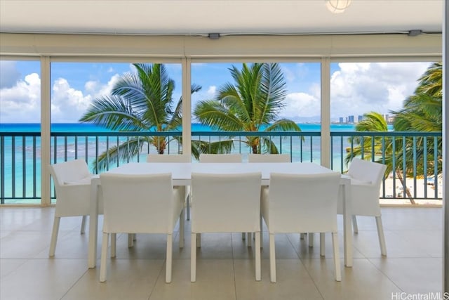 sunroom featuring a water view