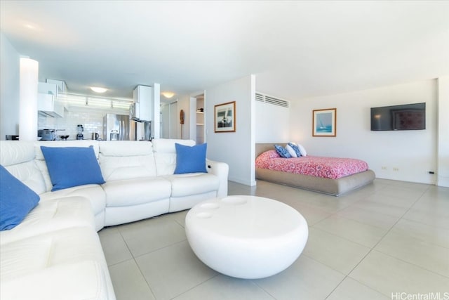 bedroom featuring light tile patterned floors and stainless steel refrigerator with ice dispenser