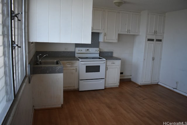 kitchen featuring sink, dark wood-type flooring, white electric range, and white cabinetry