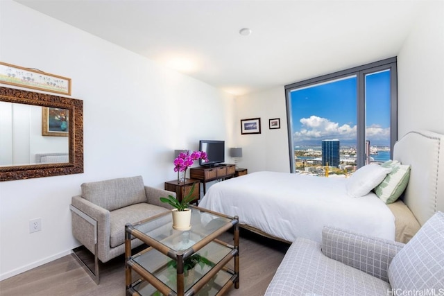 bedroom featuring baseboards and wood finished floors