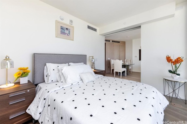 bedroom with wood finished floors and visible vents