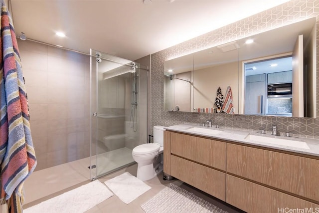 full bath featuring a stall shower, a sink, and decorative backsplash