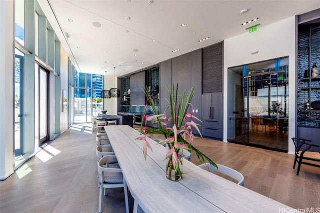 dining room featuring expansive windows and wood finished floors