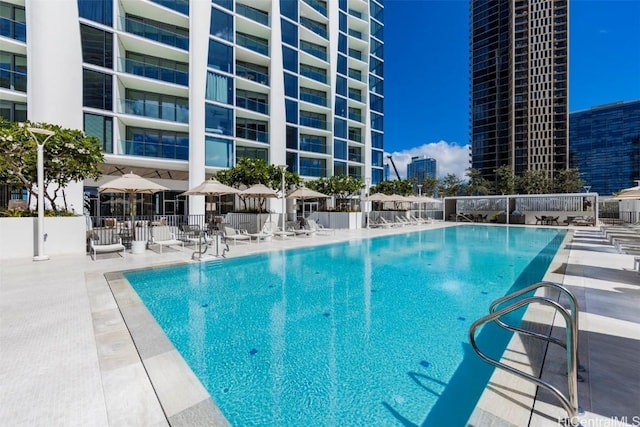 community pool featuring fence and a patio