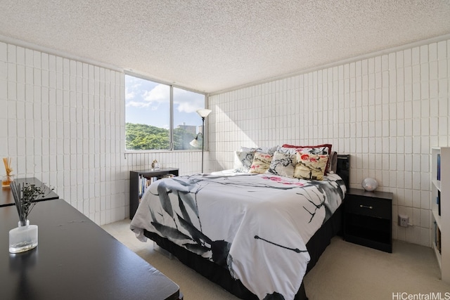 bedroom with light carpet, a textured ceiling, and tile walls