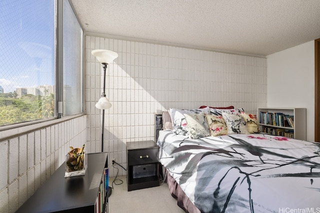 bedroom with a textured ceiling and light colored carpet