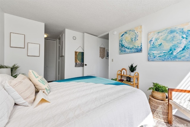 bedroom featuring a textured ceiling and wood-type flooring