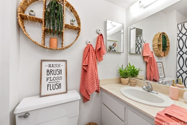 bathroom featuring vanity and toilet