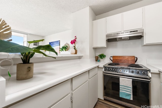 kitchen with stove, white cabinetry, and a textured ceiling