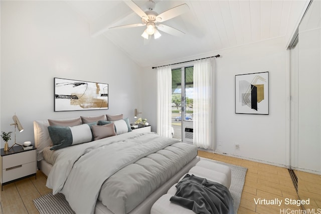 bedroom featuring ceiling fan, light hardwood / wood-style flooring, and lofted ceiling with beams