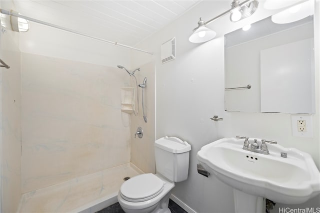 bathroom with toilet, a shower, and sink