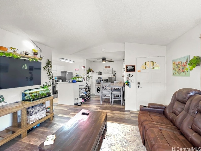 living room with hardwood / wood-style floors, ceiling fan, lofted ceiling, and a textured ceiling