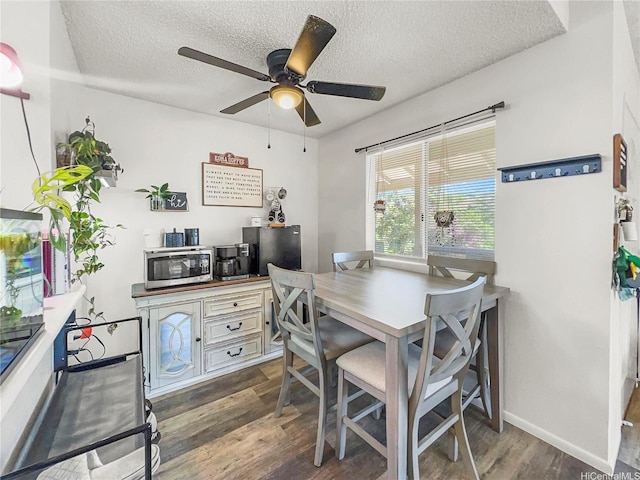 95-510 Wikao St Unit F201, Mililani, HI 96789 - dining area featuring dark wood-style flooring, a textured ceiling, ceiling fan, and baseboards