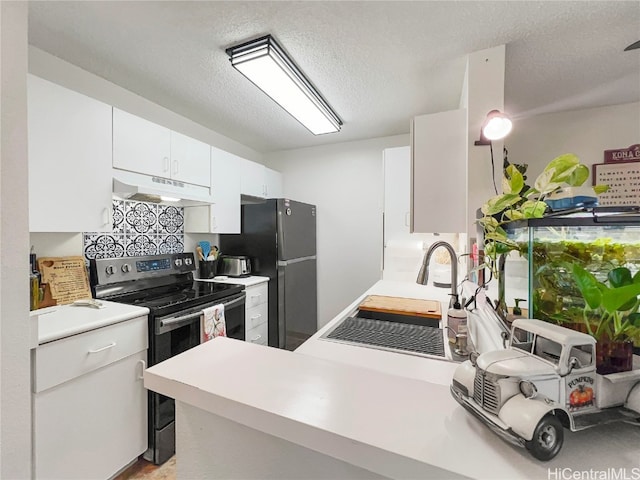 kitchen featuring stainless steel electric stove, black refrigerator, kitchen peninsula, a textured ceiling, and white cabinetry