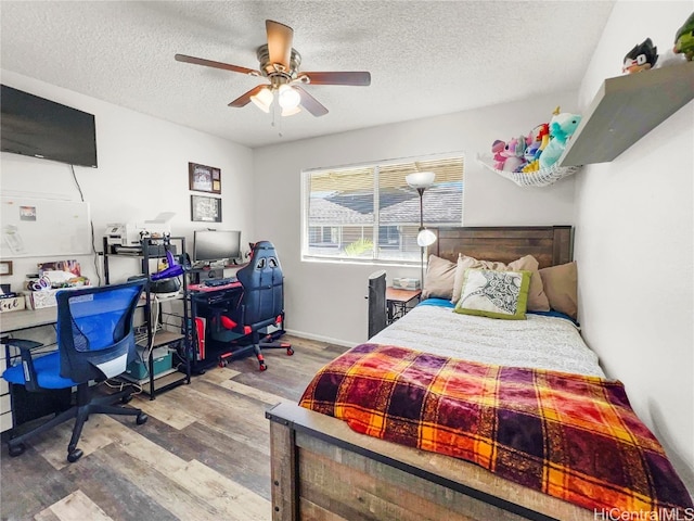 bedroom with ceiling fan, a textured ceiling, and hardwood / wood-style flooring