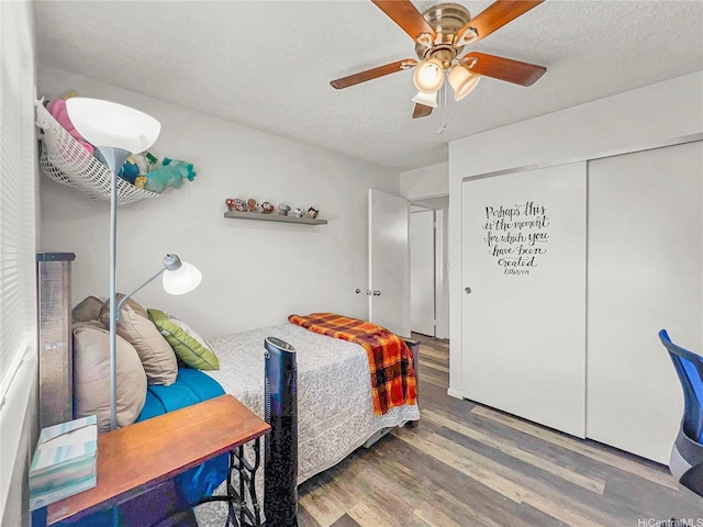95-510 Wikao St Unit F201, Mililani, HI 96789 - bedroom featuring a closet, a ceiling fan, a textured ceiling, and wood finished floors