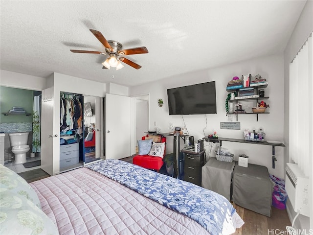 bedroom featuring ensuite bathroom, hardwood / wood-style flooring, ceiling fan, a textured ceiling, and a closet