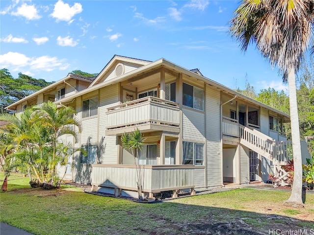 exterior space with a yard and a balcony