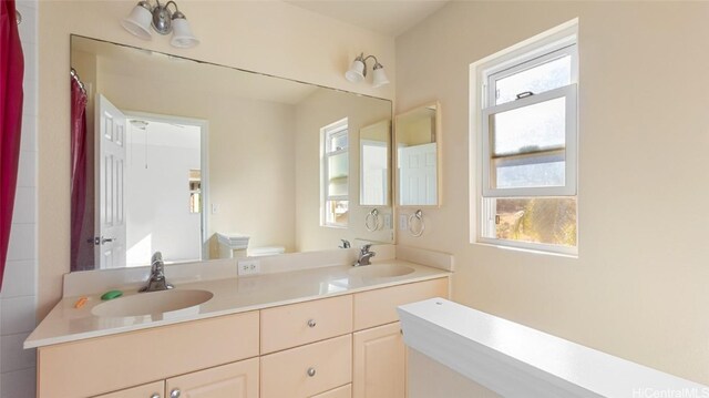 bathroom featuring vanity and toilet