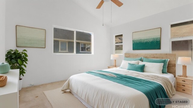 carpeted bedroom with ceiling fan and high vaulted ceiling