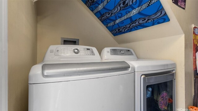 clothes washing area with washer and clothes dryer