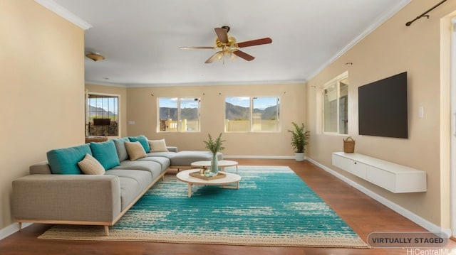 living room with ornamental molding, wood-type flooring, and ceiling fan