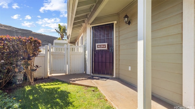 view of exterior entry with a lawn