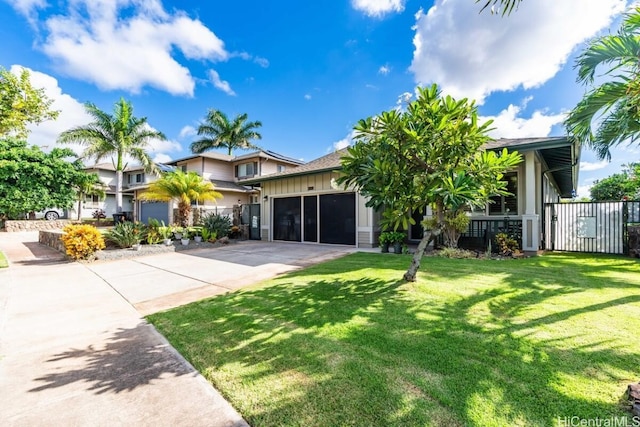 view of front of home with a garage and a front lawn