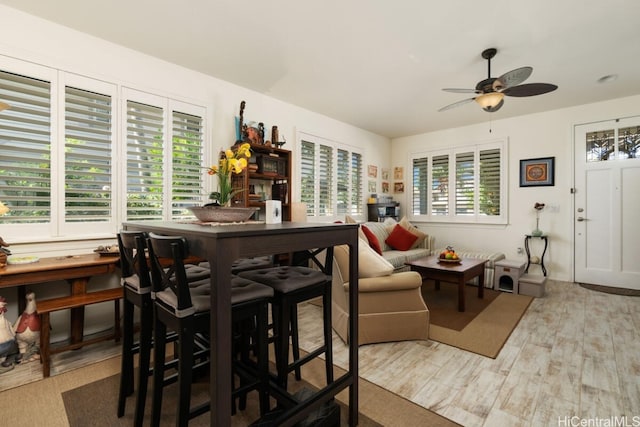 dining area with light hardwood / wood-style flooring, a healthy amount of sunlight, and ceiling fan