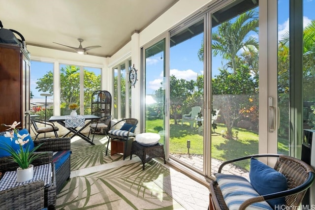 sunroom / solarium featuring ceiling fan