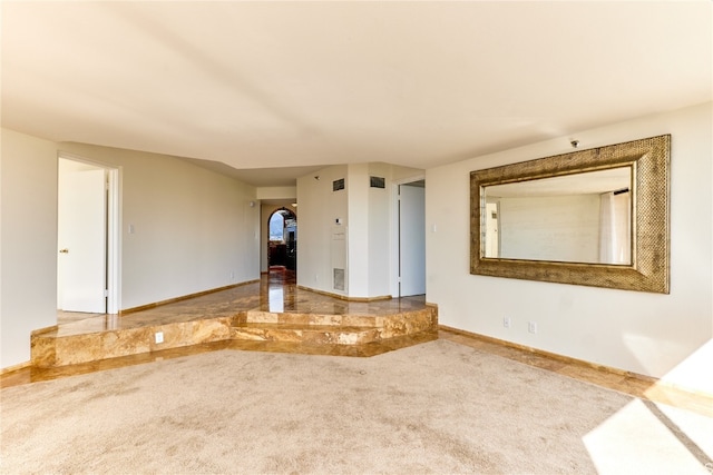 unfurnished living room featuring carpet floors