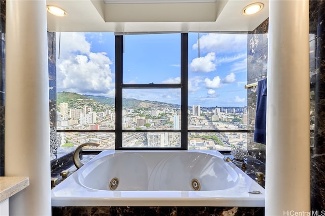 bathroom with a mountain view and tiled tub