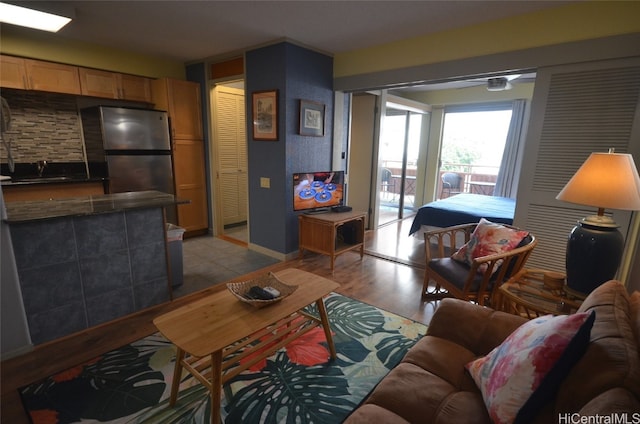 living room with sink and light hardwood / wood-style flooring